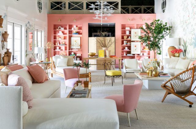 large indoor seating area with pink walls and floral wallpaper